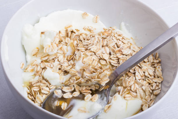 istock A white plate half full with oats with yogurt and honey, with a spoon inside 835529434