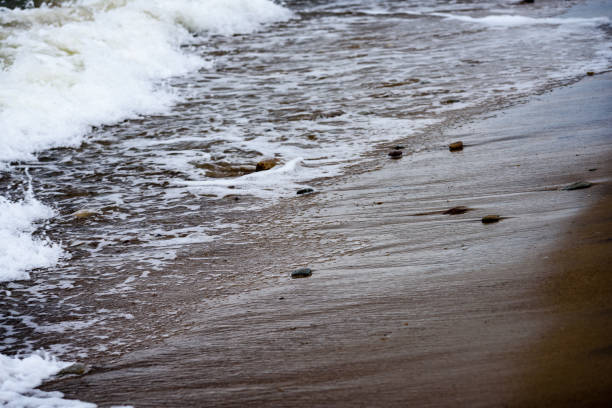 Low angle view of small wave crashing onto shore