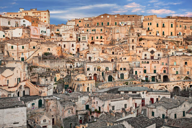 Matera, Basilicata, Italy: view at sunrise of the old town Matera, Basilicata, Italy: cityscape at sunrise of the picturesque old town (sassi di Matera) with the characteristics ancient tuff houses tufa photos stock pictures, royalty-free photos & images
