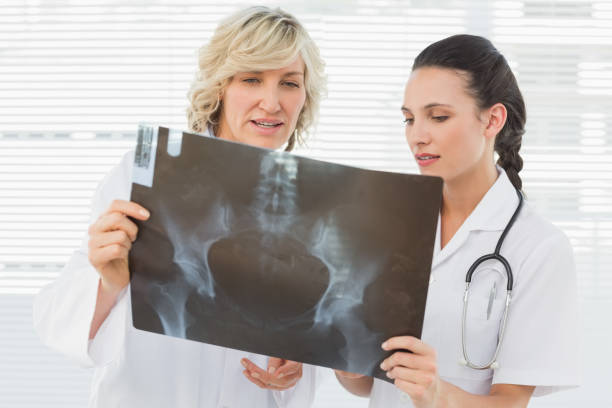 istock Two serious female doctors examining xray 835562102