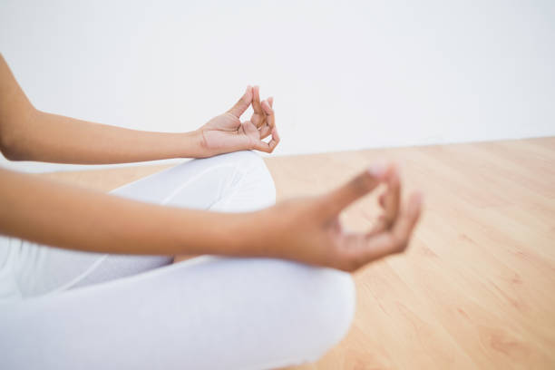istock Mid section of slender young woman meditating 835565410