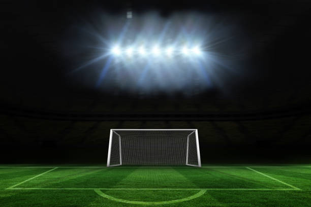 istock Football pitch and goal under spotlights 835569940