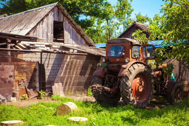 istock Tractor near an old wooden house 835573276