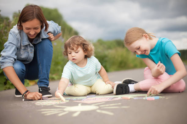 istock Babysitter or kindergarten concept. Children drawing with colo chalk. 835595436