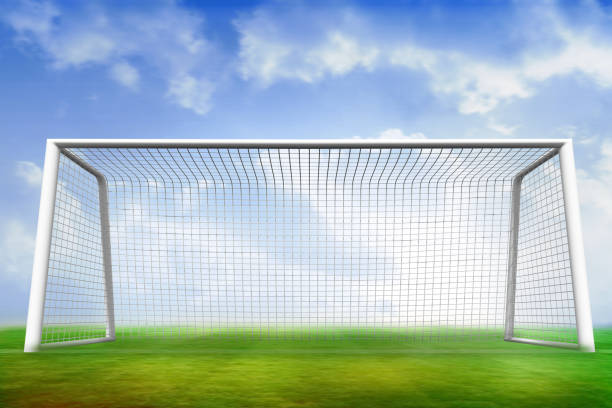 Digitally generated football pitch and goal under blue sky