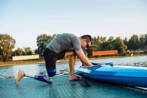 istock Amputee sportsman adjusting his kayak for training 835610052