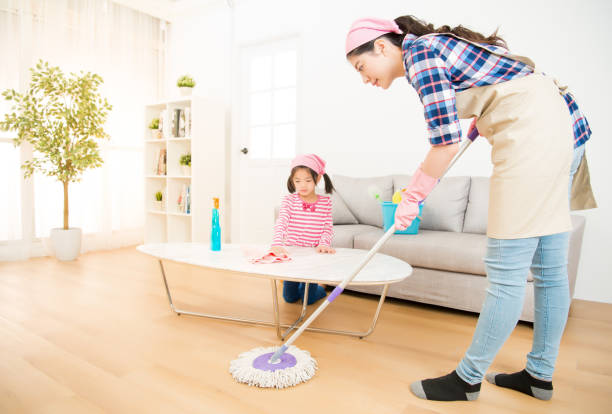 istock mum teaching daughter cleaning home 835616890