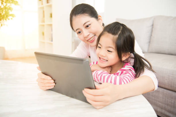 istock woman and her little daughter using pad 835619274