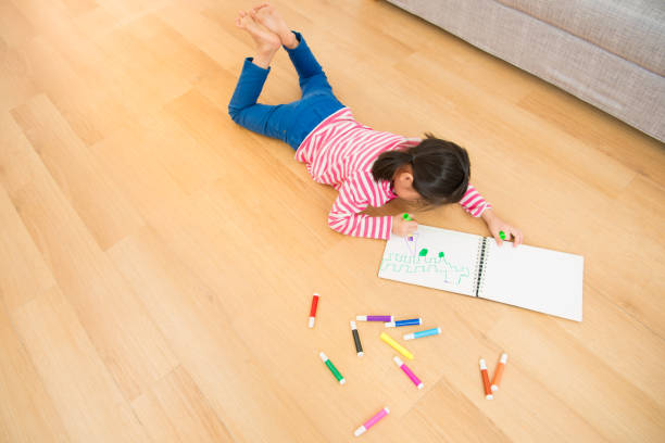 istock Children lying down near sketchbooks 835619722