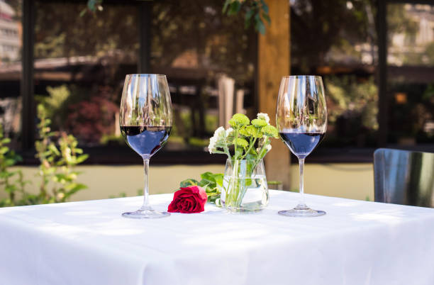 istock rose flower with wine at table in restaurant 835619832