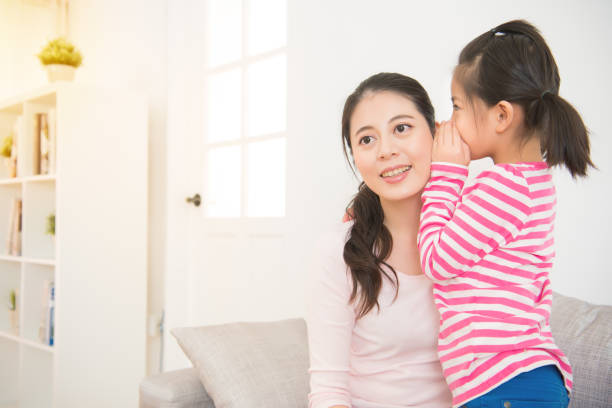 istock Daughter whispering to mom a secret 835619916