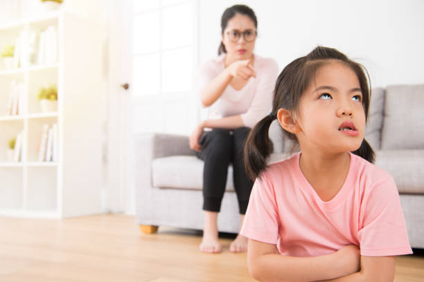asian mother sitting on the sofa angry pointing asian mother sitting on the sofa angry pointing asian spoiled child stock pictures, royalty-free photos & images