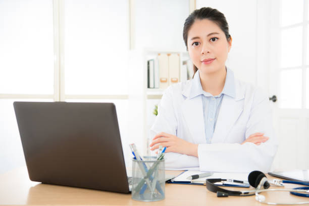 istock confident female doctor sitting at office desk 835622070