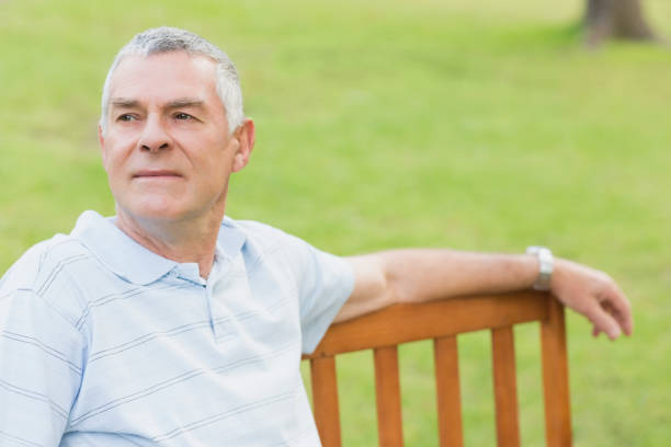 istock Smiling senior man relaxing at the park 835626582