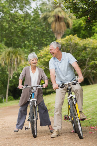 istock Cheerful senior couple on cycle ride in countryside 835632464
