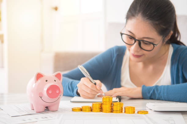 istock woman counting and recording her savings 835635342