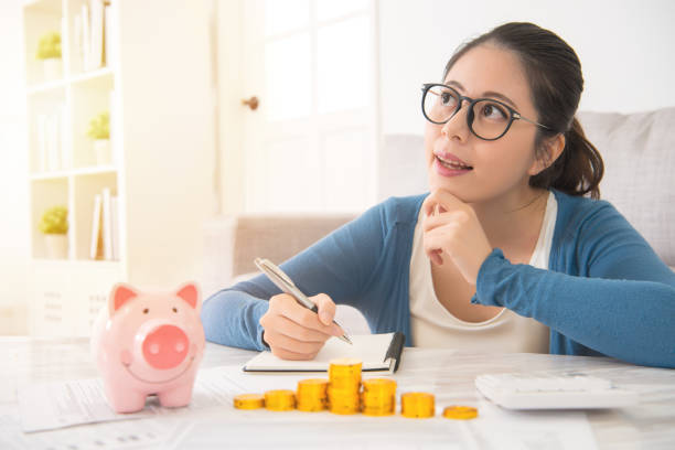 istock woman dreaming and recording her savings 835635354