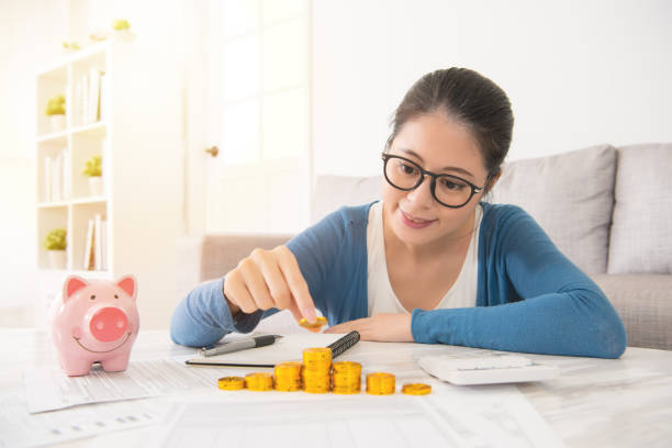 istock woman counting money tower from savings 835635736