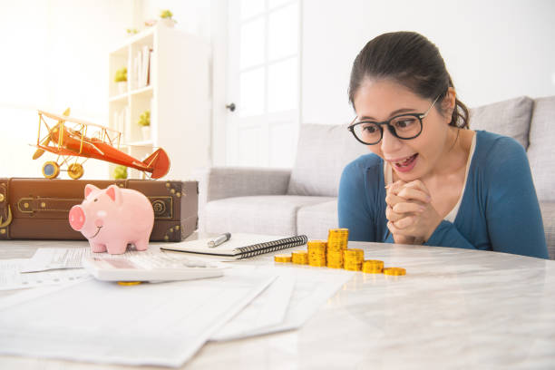 istock housewife cheerful looking stack of gold coins 835635796