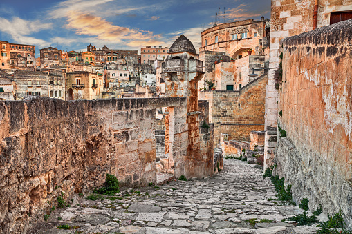 Matera, Basilicata, Italy: picturesque view at sunrise of an ancient alley in the old town \