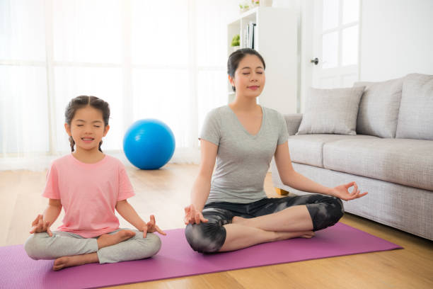 mother with children meditating doing yoga