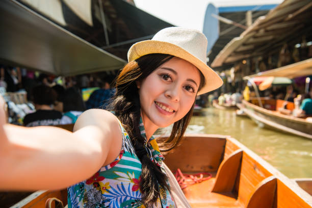 istock women taking selfie on floating market holiday 835641940