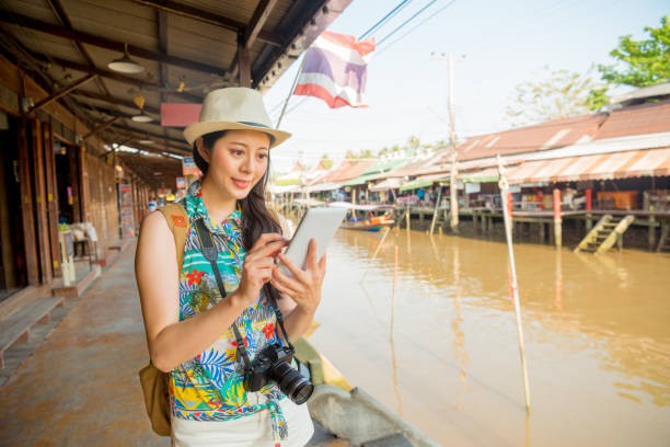 istock smiling blogger traveler holding mobile 835644646