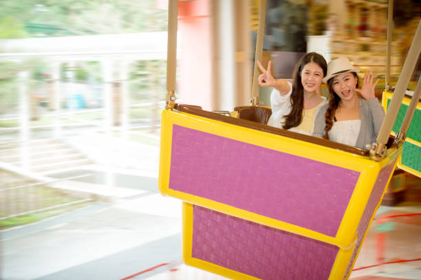 istock friends playing the rotation fast flying chair 835647380