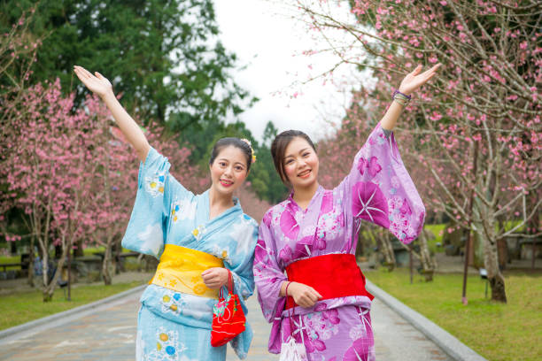 istock Two women open arms with cherry-blossom 835649876