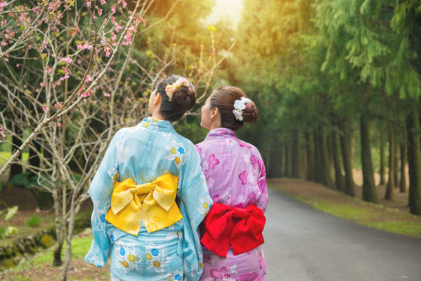 istock Asian girlfriends looking at pink flowers 835649982