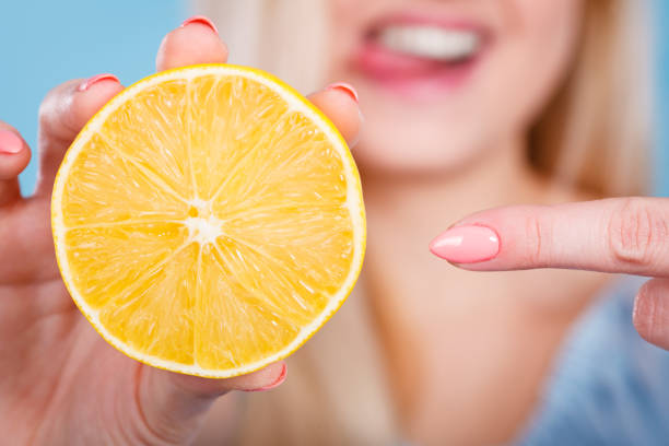 istock Woman holding fruit lemon or orange 835668200