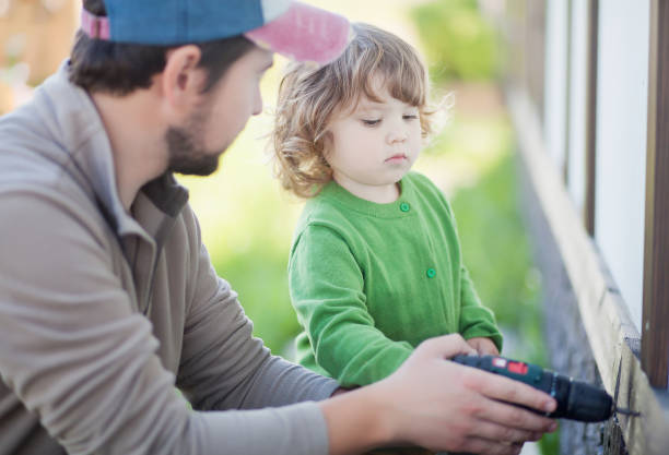 istock Father teachs his toddler daughter how to drill 835671484