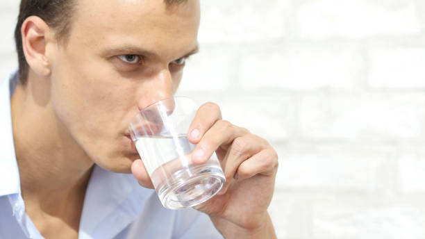 istock Handsome businessman in casual cloth  drinking water in office 835671832