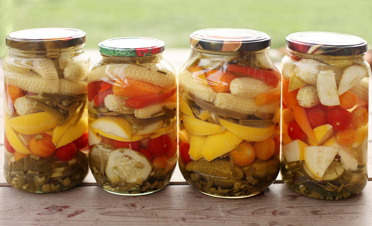 horizontal natural light photo pickles of various vegetables in jars