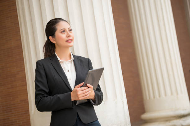 istock female lawyer holding digital tablet computer 835677182