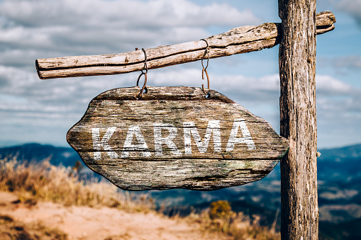 Karma text on a wooden sign board.