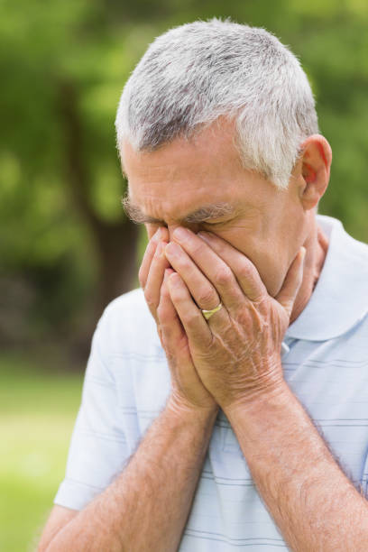 istock Senior man with head in hands at park 835703318
