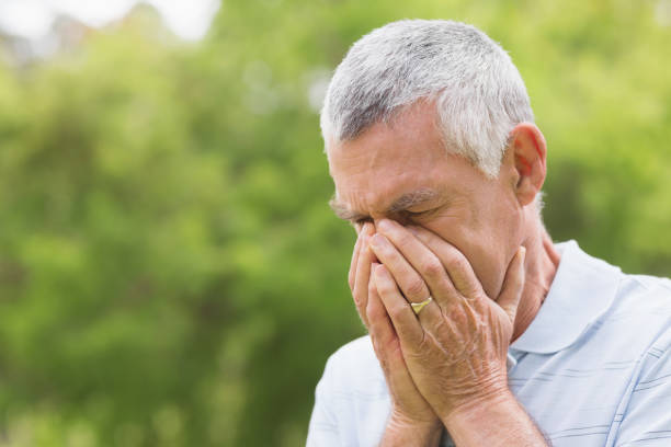 istock Senior man with head in hands at park 835703334