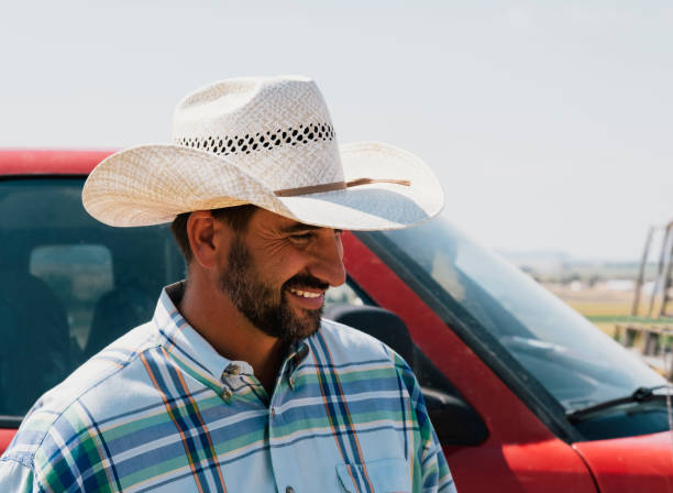 istock Cowboy Smiling Beside A Truck 835703416