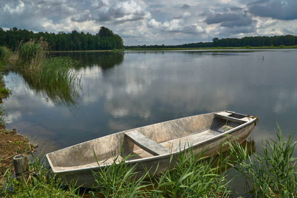 istock A boat moored on the shore of a lake 835703458