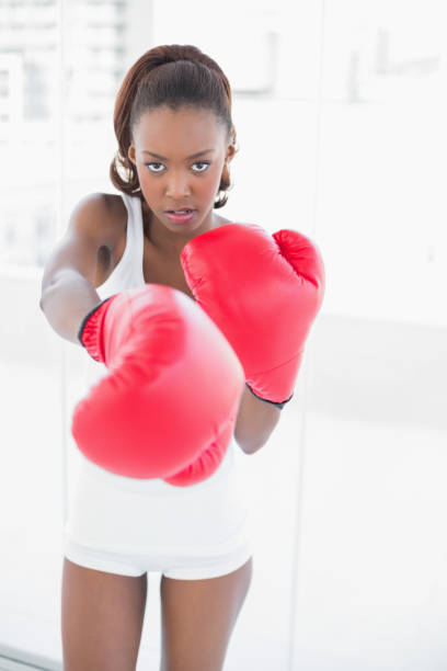 istock Slender athletic woman boxing 835703694