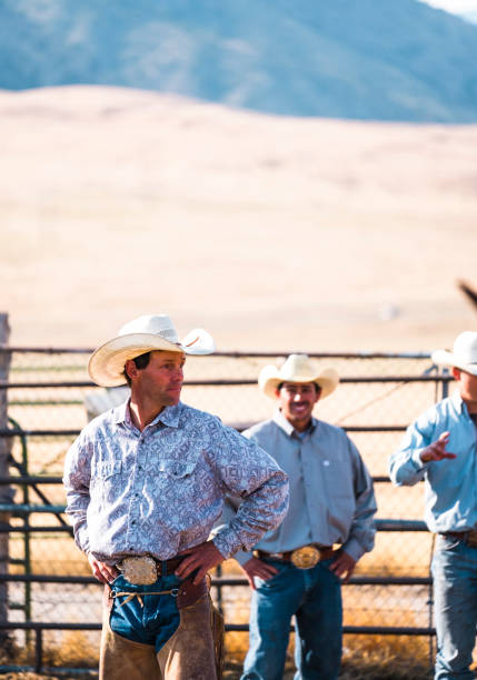 istock Two Cowboys Stand Talking At A Fence 835710574