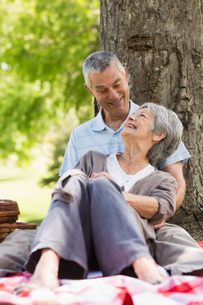 istock Happy relaxed senior couple sitting at park 835730300