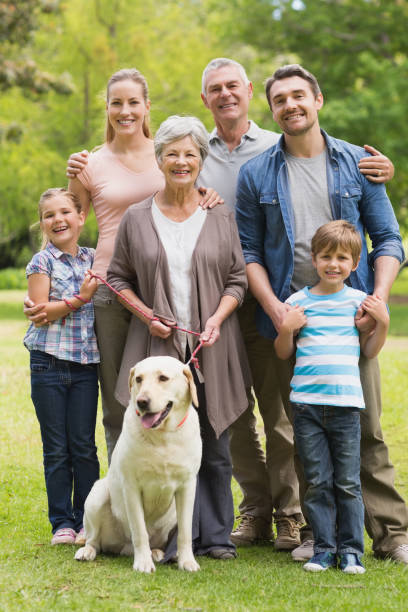 istock Extended family with their pet dog at park 835733068