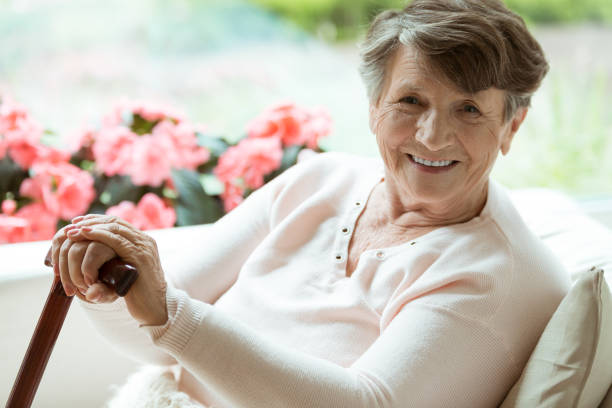 istock Woman with walking stick smiling 835733120