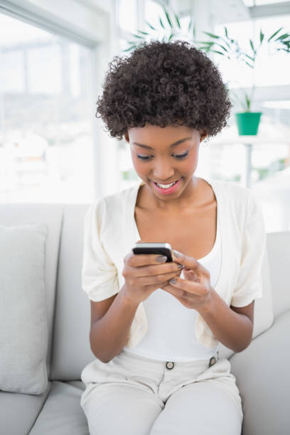 istock Relaxed gorgeous brunette holding her smartphone 835733210