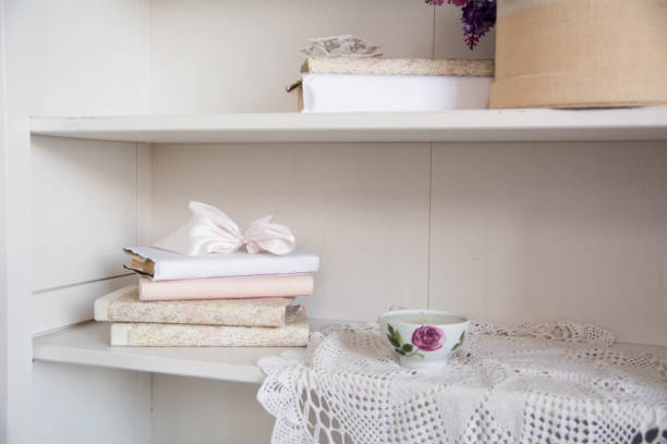 istock Rack with old books and a porcelain cup 835735678