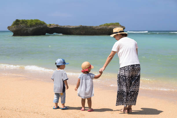 istock Twin and mom enjoying on the beach 835740344