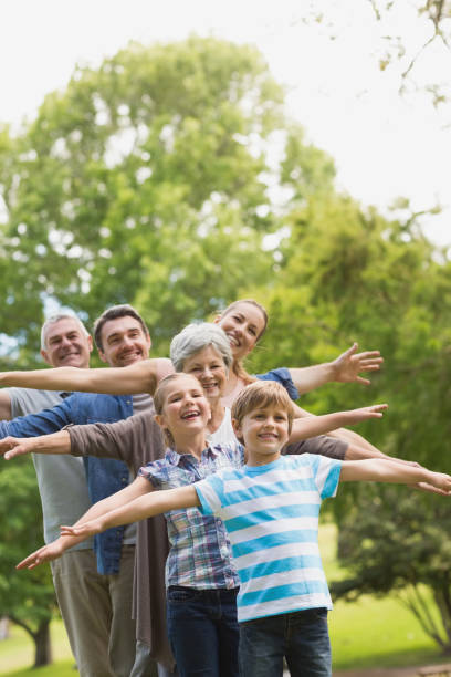 istock Extended family stretching hands at park 835743304
