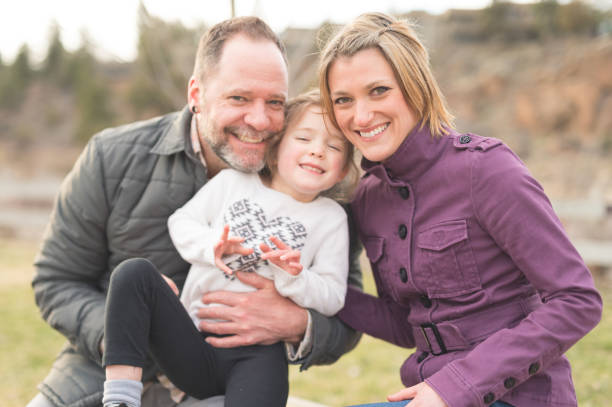 istock Modern couple poses on nature walk with their young daughter 835743628
